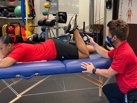 author measuring active knee flexion with smartphone