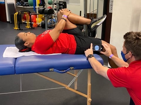 author measuring passive hip extension with smart phone
