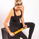 woman self-massaging soft tissue in leg