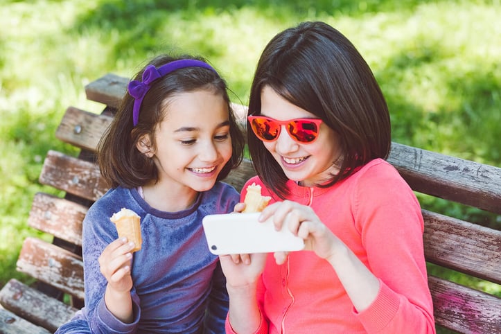 Two Little Girls Playing on a Phone