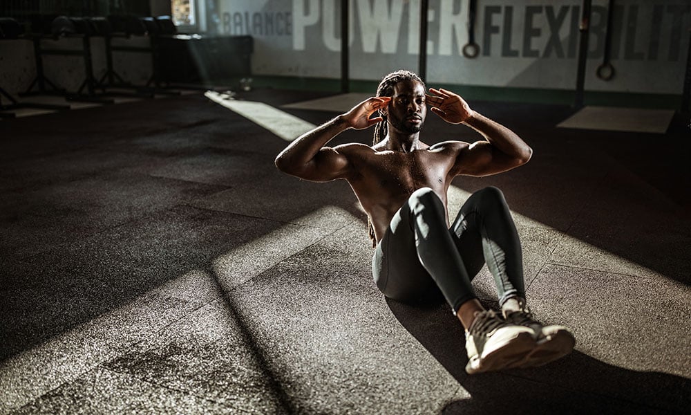 man doing crunches in a gym