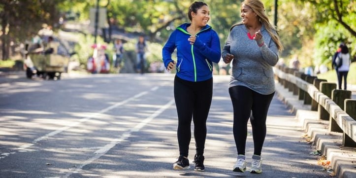 Two females running outside in a marathon