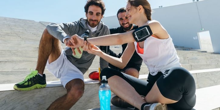 A Woman Showing Men Her Smart Watch