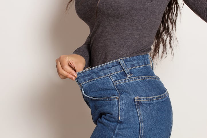 woman stretching jean waist band