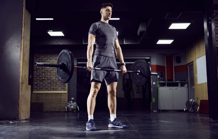 A man doing a deadlift in the gym