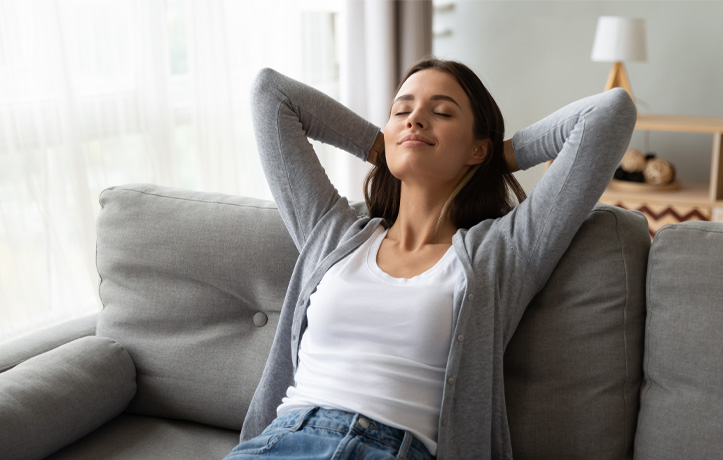 A rested woman sitting on a couch
