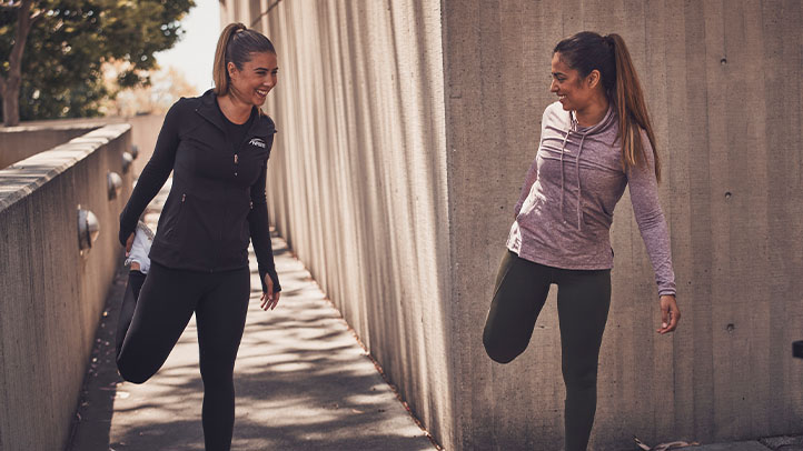 Woman NASM trainer with client stretching