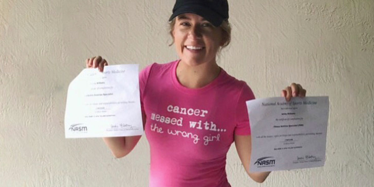 ashley williams holding up her nasm certification