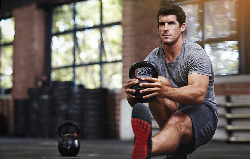 a man doing a functional training kettlebell squat