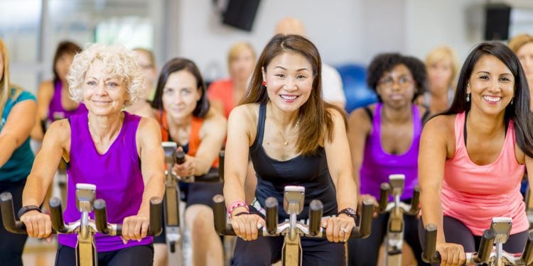 Group fitness class taking cycling class