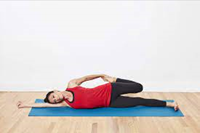 woman doing a laying down quad stretch