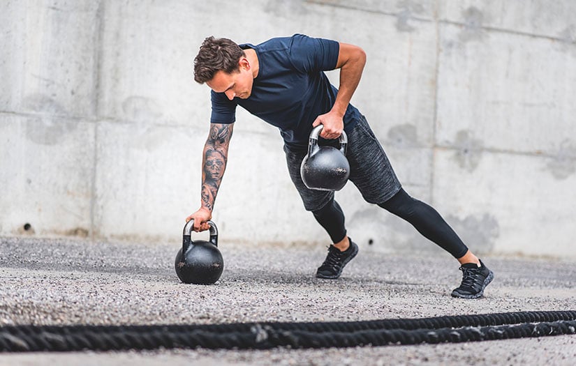 a man doing a kettlebell workout outside