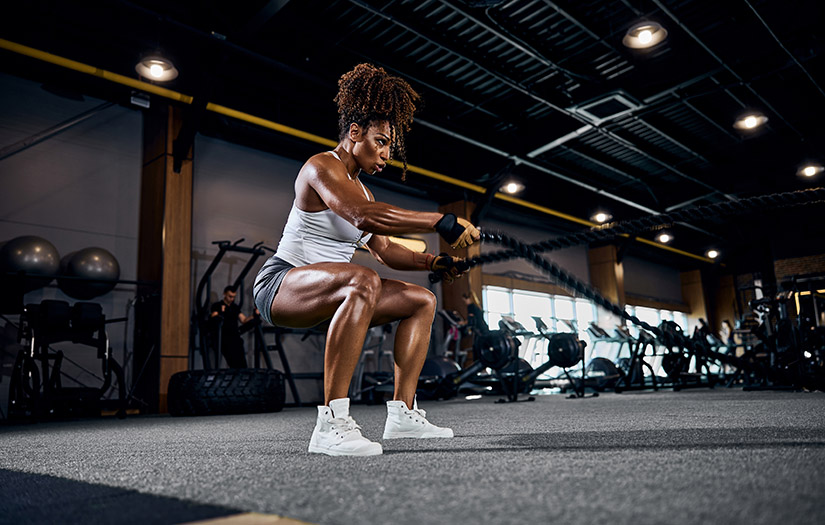 a woman doing battle ropes training