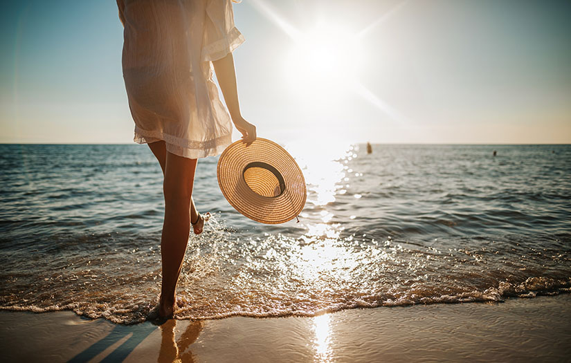 a woman at the beach on a wellness retreat