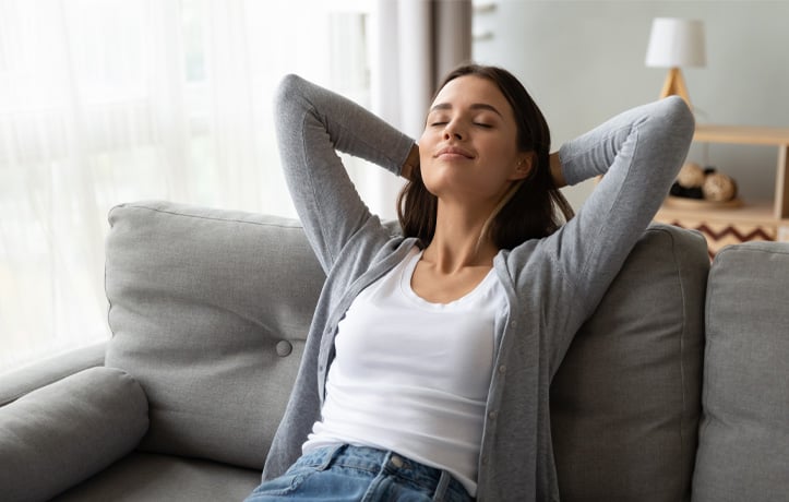 A rested woman sitting on a couch